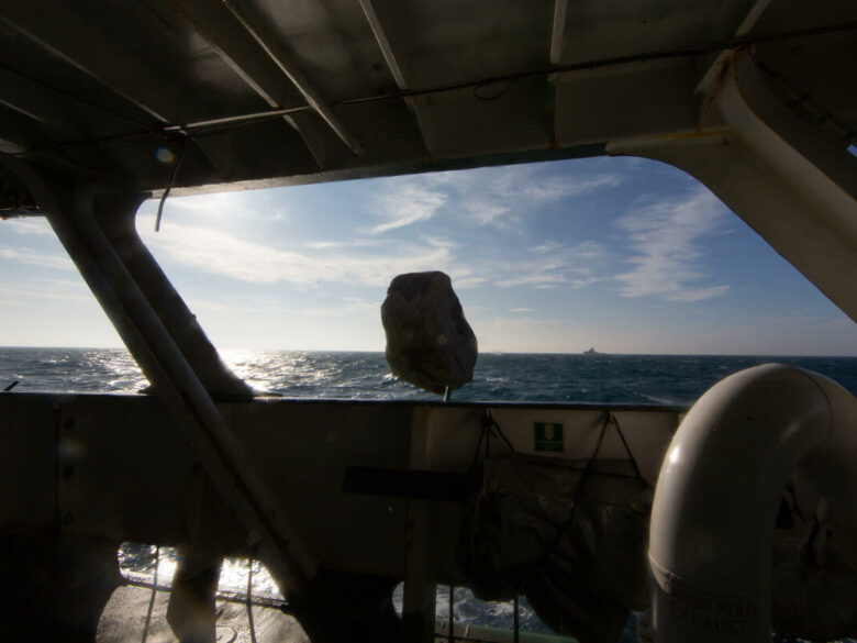 A boulder falls into the English channel from MY Esperanza. © Suzanne Plunkett