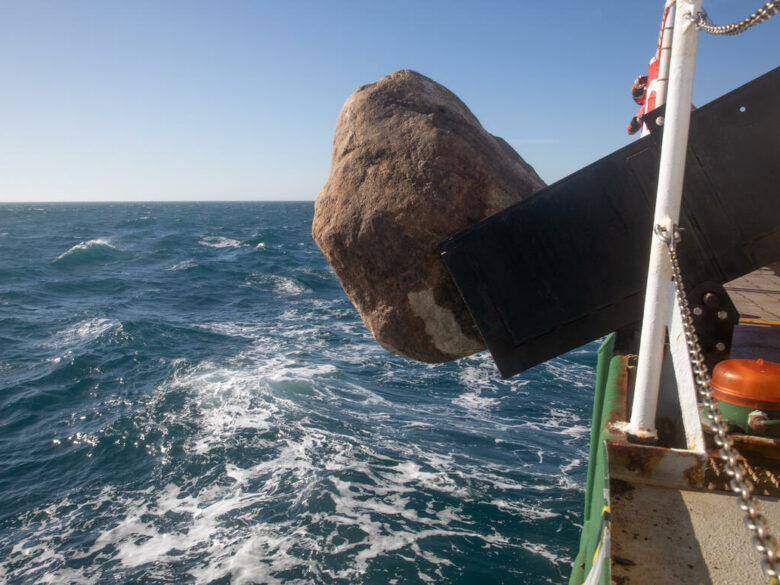 A boulder falls into the English channel from MY Esperanza. © Suzanne Plunkett