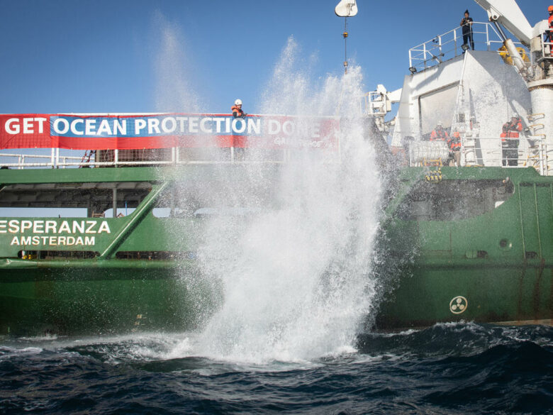 A boulder falls into the English channel from MY Esperanza. © Suzanne Plunkett