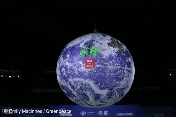 Banderole de Greenpeace installée sur le globe géant de la COP26 lors des dernières heures du sommet